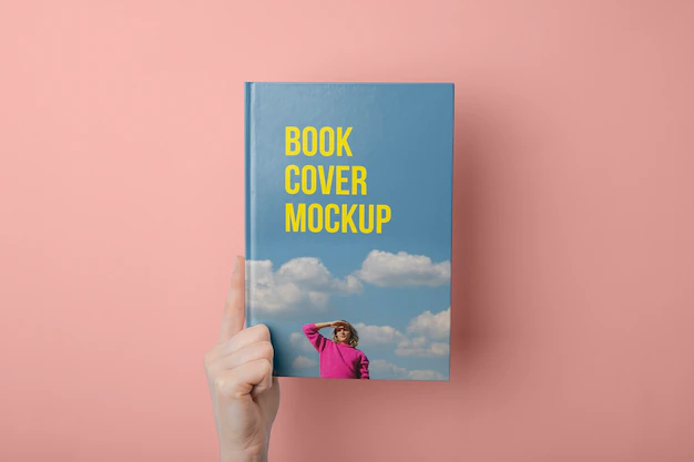 Free PSD | Hand holding  book mockup