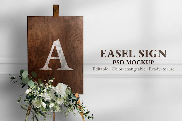 Free PSD | Wedding easel sign mockup psd in wooden texture with flowers