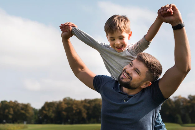 Free Photo | Father and son having a good time in the park