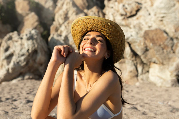 Free Photo | Smiley woman at beach high angle