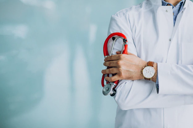 Free Photo | Young handsome physician in a medical robe with stethoscope