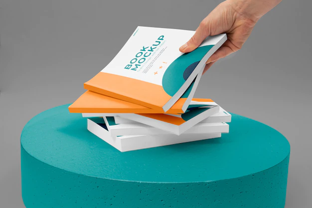 Free PSD | Hand holding book mockup