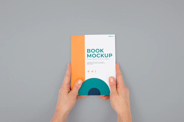 Free PSD | Hand holding book mockup