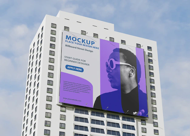 Free PSD | Billboard mockup on tall building on the street