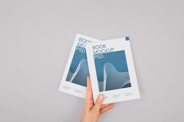 Free PSD | Hand holding book mockup