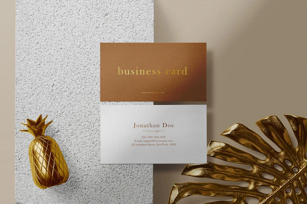 Free PSD | Clean minimal business card mock up on concrete with gold leaf