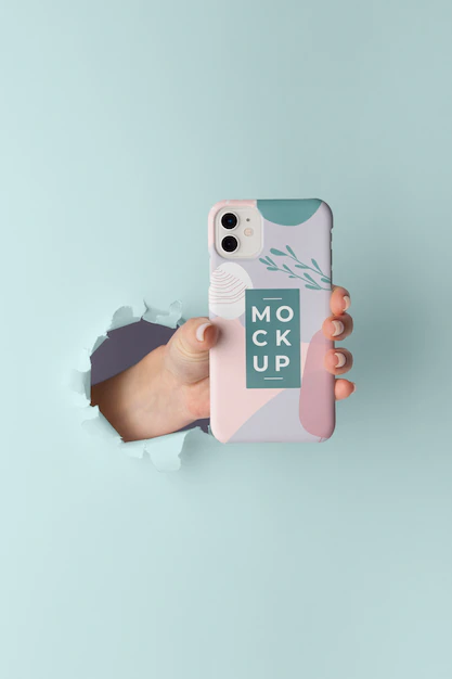 Free PSD | Hand holding smartphone with mock-up phone case through wall tear