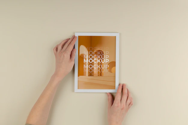 Free PSD | Above view hands holding white frame