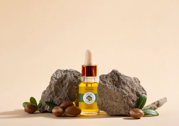 Free PSD | Argan oil cosmetic bottle mock-up with rock