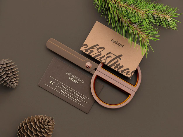 Free PSD | Business card mockup with fancy scissor and pine leaves and cones top view
