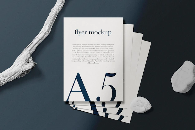 Free PSD | Clean minimal a5 flyer mockup on top background with stick and white stone. psd file.