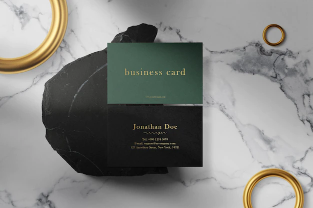 Free PSD | Clean minimal business card mock up on black stone with rings