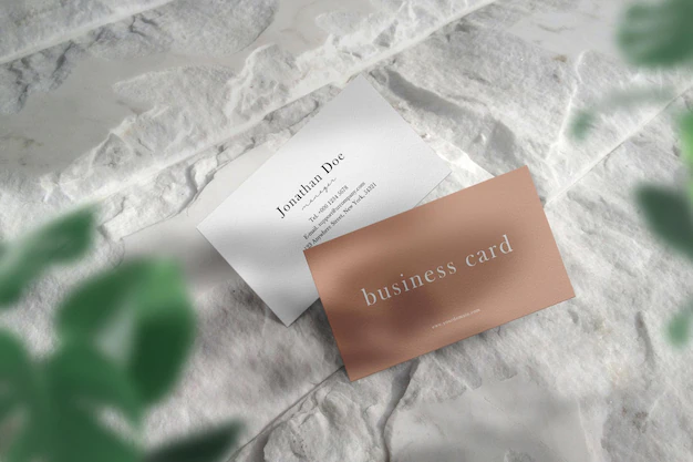Free PSD | Clean minimal business card mockup on white stone floor and light shadow.