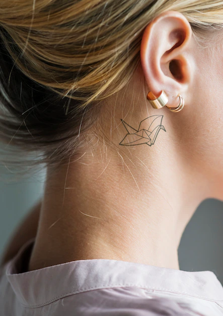 Free PSD | Closeup of a simple behind the ear tattoo of a young woman