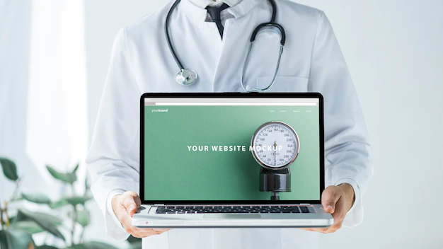 Free PSD | Doctor holding laptop mockup for website