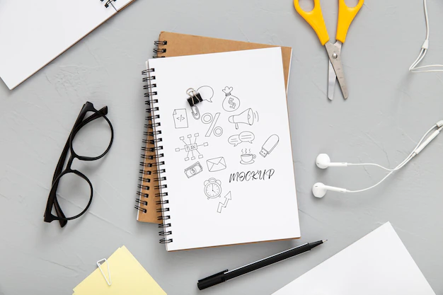 Free PSD | Flat lay of desk surface with earphones and notebooks