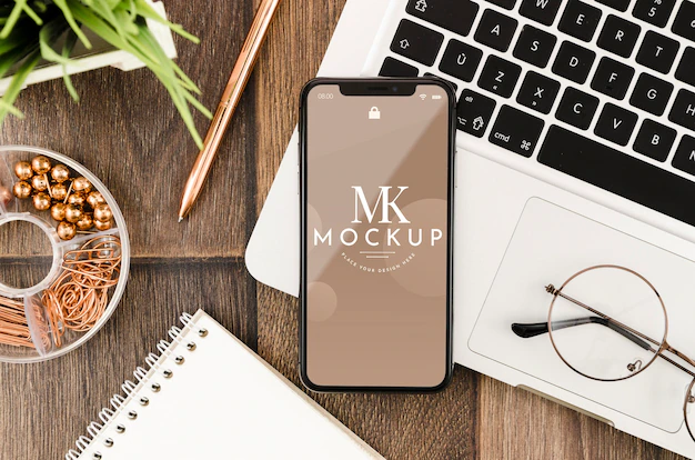 Free PSD | Flat lay smartphone mock-up on laptop with glasses