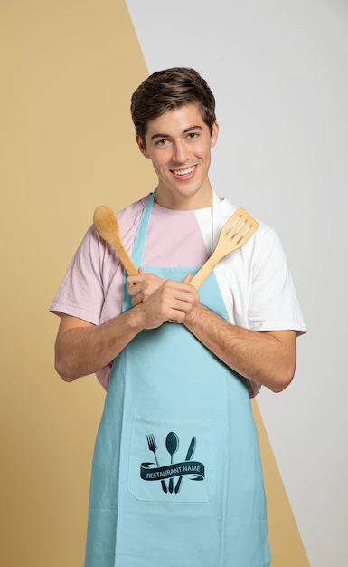 Free PSD | Front view of man in apron holding wooden spoons