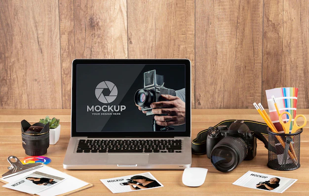 Free PSD | Front view of photographer wooden workspace with laptop