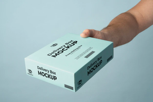 Free PSD | Hand holding blue delivery pack mockup
