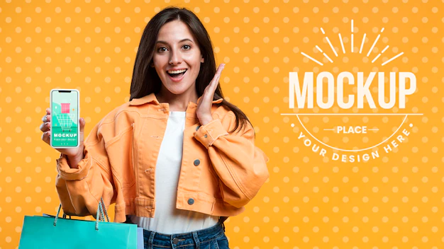 Free PSD | Happy woman holding shopping bags and a phone mock-up