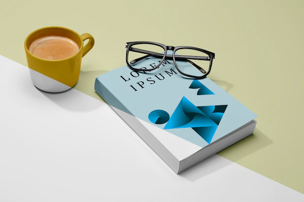 Free PSD | High angle book mock-up with glasses and coffee