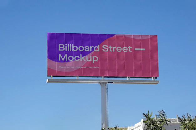 Free PSD | Large billboard mockup on clean blue sky