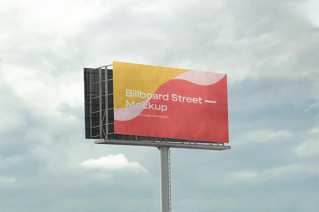 Free PSD | Large billboard mockup on cloudy sky