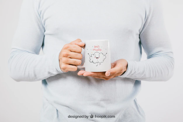 Free PSD | Mock up design with hands holding a coffee mug