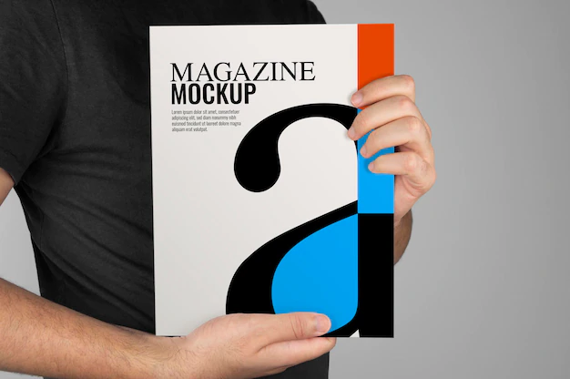 Free PSD | Mockup of model holding a magazine