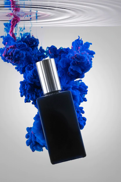 Free PSD | Perfume bottle and vivid blue smoke mockup