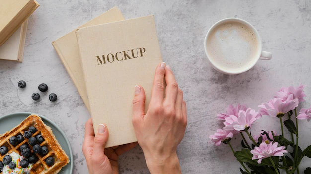 Free PSD | Person holding a mock-up book
