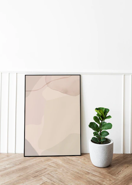 Free PSD | Picture frame mockup by a fiddle-leaf fig plant on a parquet floor
