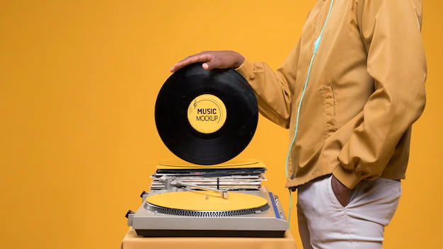 Free PSD | Side view of man holding vinyl disk for music store mock-up