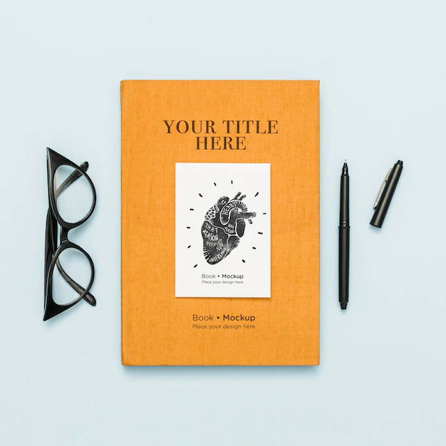 Free PSD | Top view of book with pen and glasses