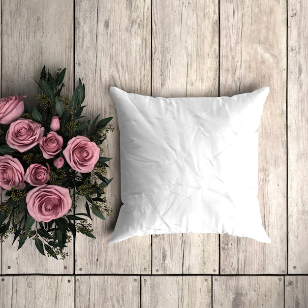Free PSD | White pillowcase mockup on a wooden plank with decorative roses
