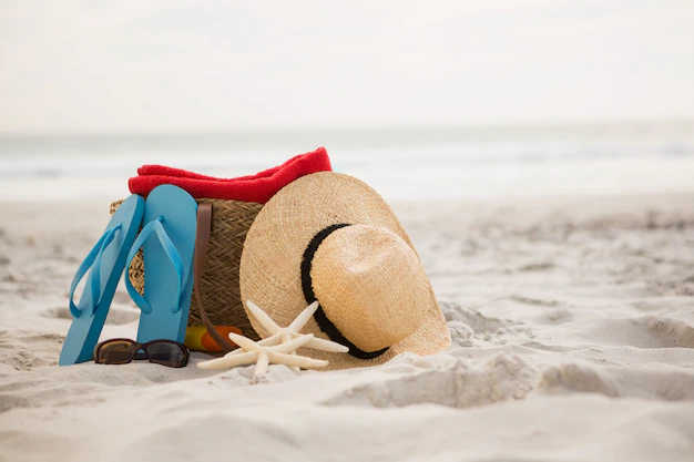 Free Photo | Bag and beach accessories kept on sand