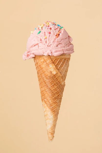 Free Photo | Cornet ice cream with a strawberry scoop on a colorful surface