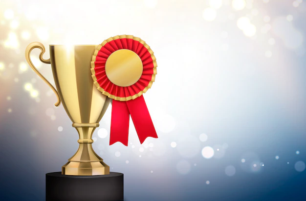 Free Vector | Winner gold trophy with red pleated badge rosette award realistic closeup composition blurry light