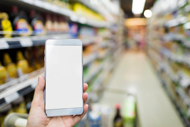 Free PSD | Browsing smartphone in supermarket