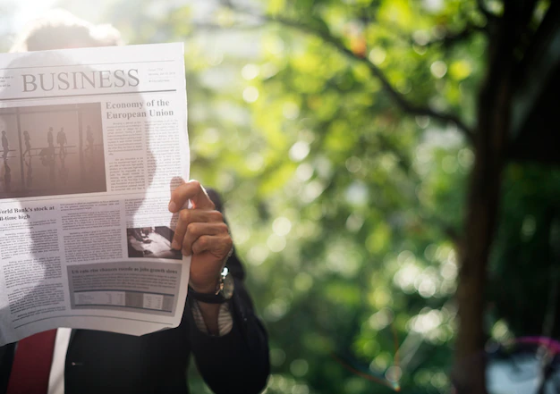 Free PSD | Businessman standing and reading newspaper