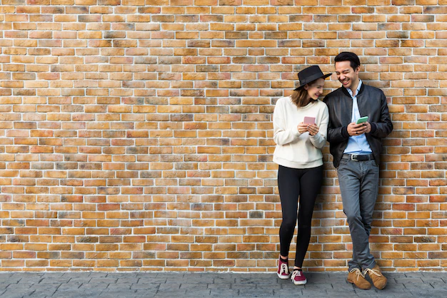 Free PSD | Couple dating in front of brick wall