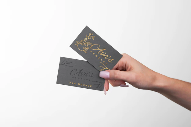 Free PSD | Embossed business card held in hand