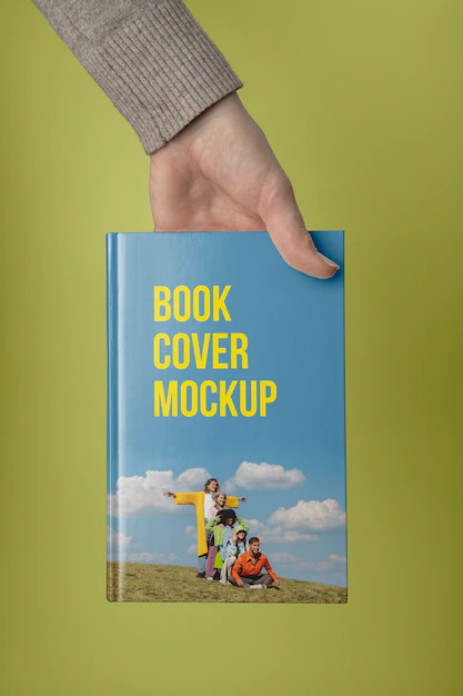 Free PSD | Hand holding  book mockup