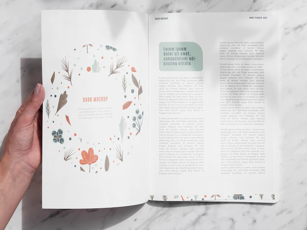 Free PSD | Hand opening a magazine on grey background