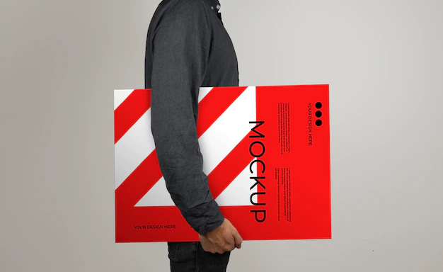 Free PSD | Mockup of a model holding a poster in horizontal position