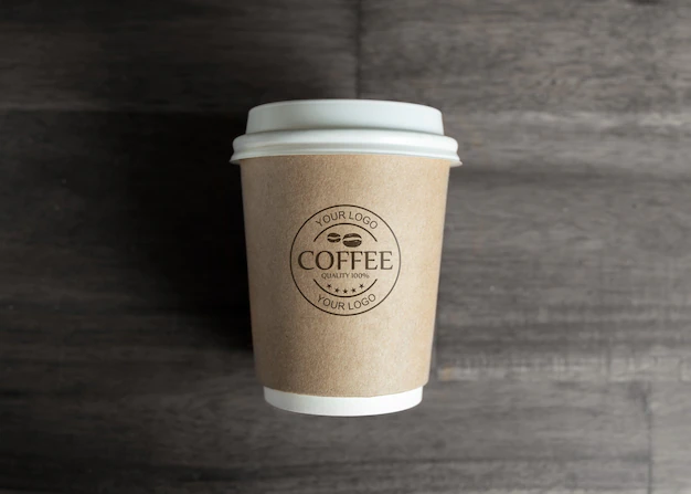 Free PSD | Paper coffee cup mockup on wooden table