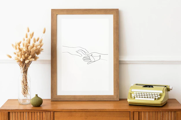 Free PSD | Picture frame mockup on a wooden sideboard table by a typewriter