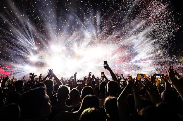 Free Photo | Excited audience watching confetti fireworks and having fun on music festival at night copy space