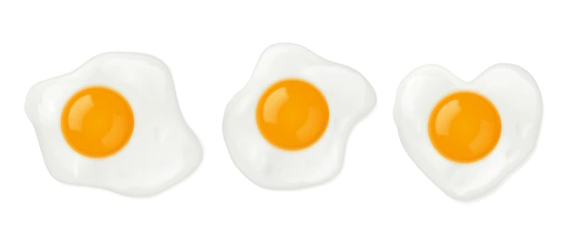Free Vector | Fried eggs in heart shape top view